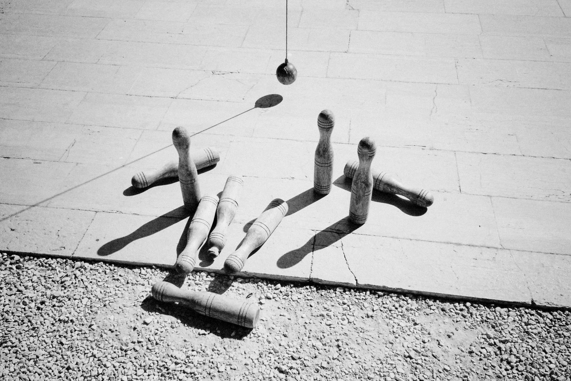 A traditional skittles game set up on a paved surface.
