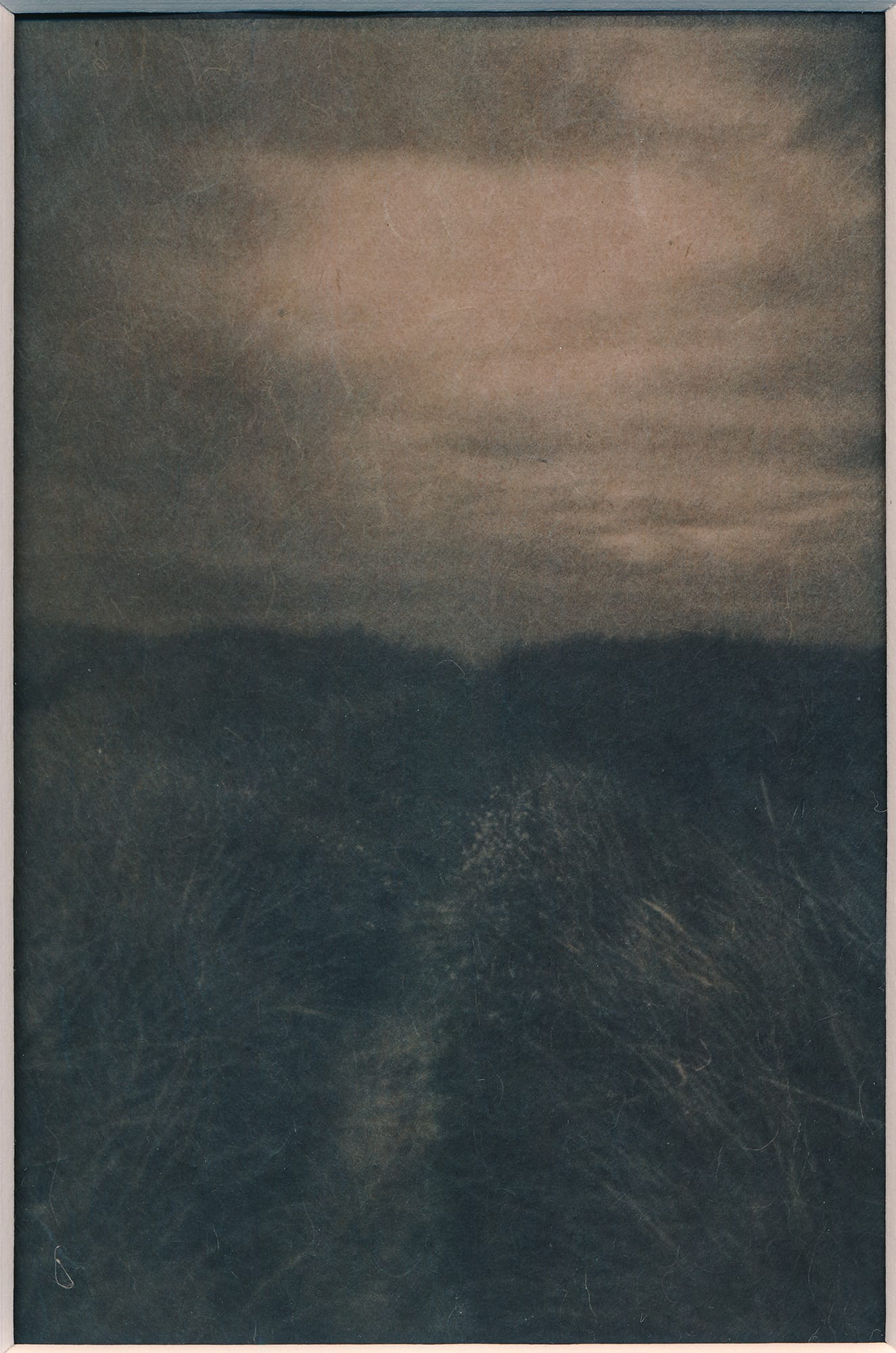 A cyanotype photograph of a serene landscape with a dark, grassy foreground and a bright, cloudy sky.