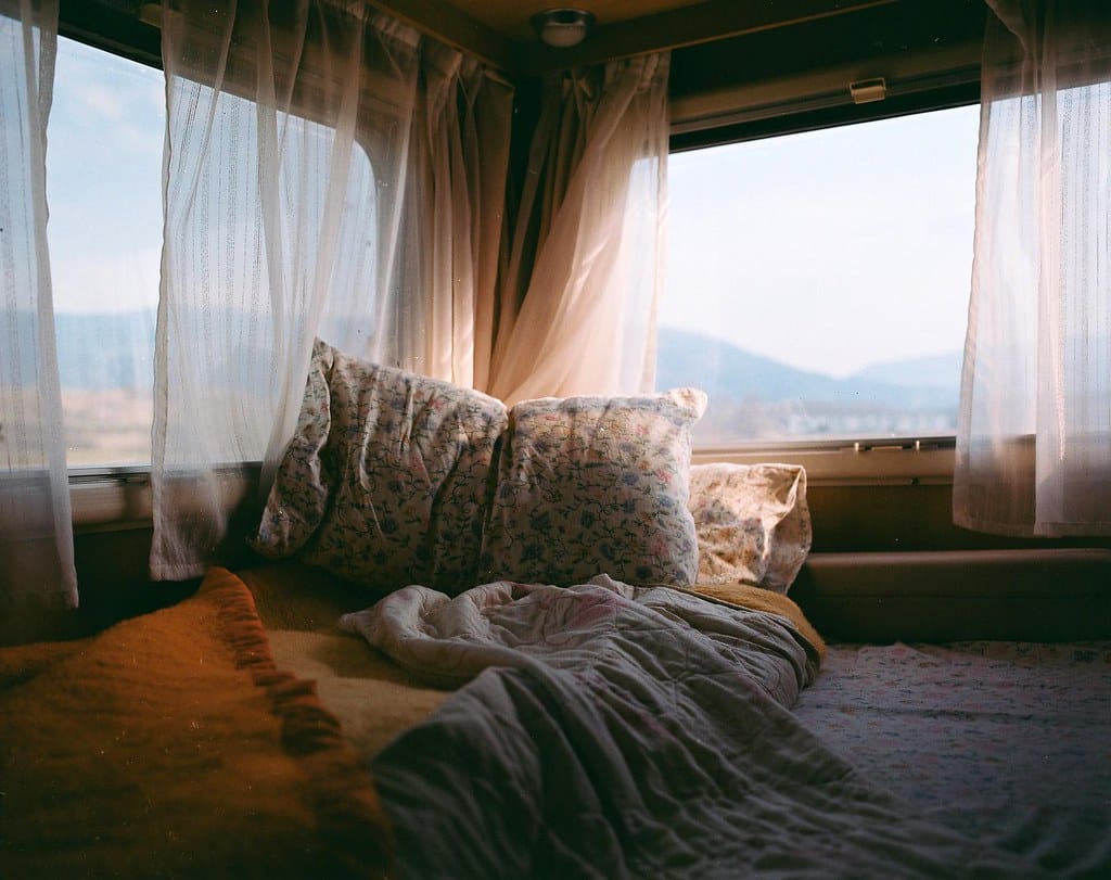 Camper van interior with a cozy bed, ready for life on the road.