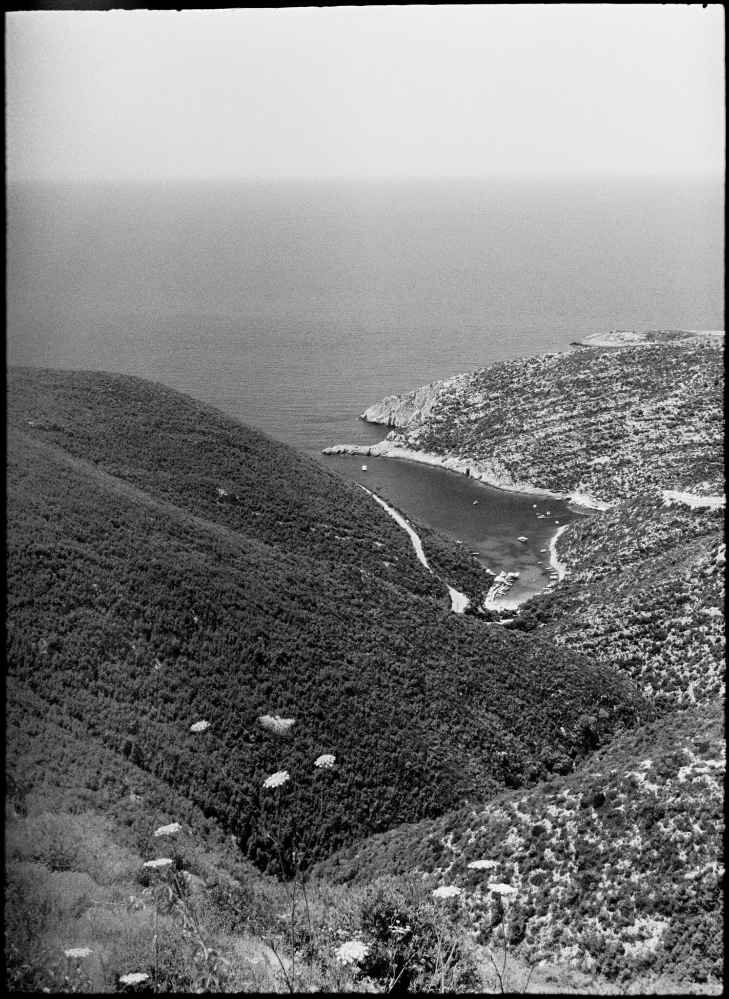 Coastal view showcasing a rugged shoreline and a peaceful inlet.