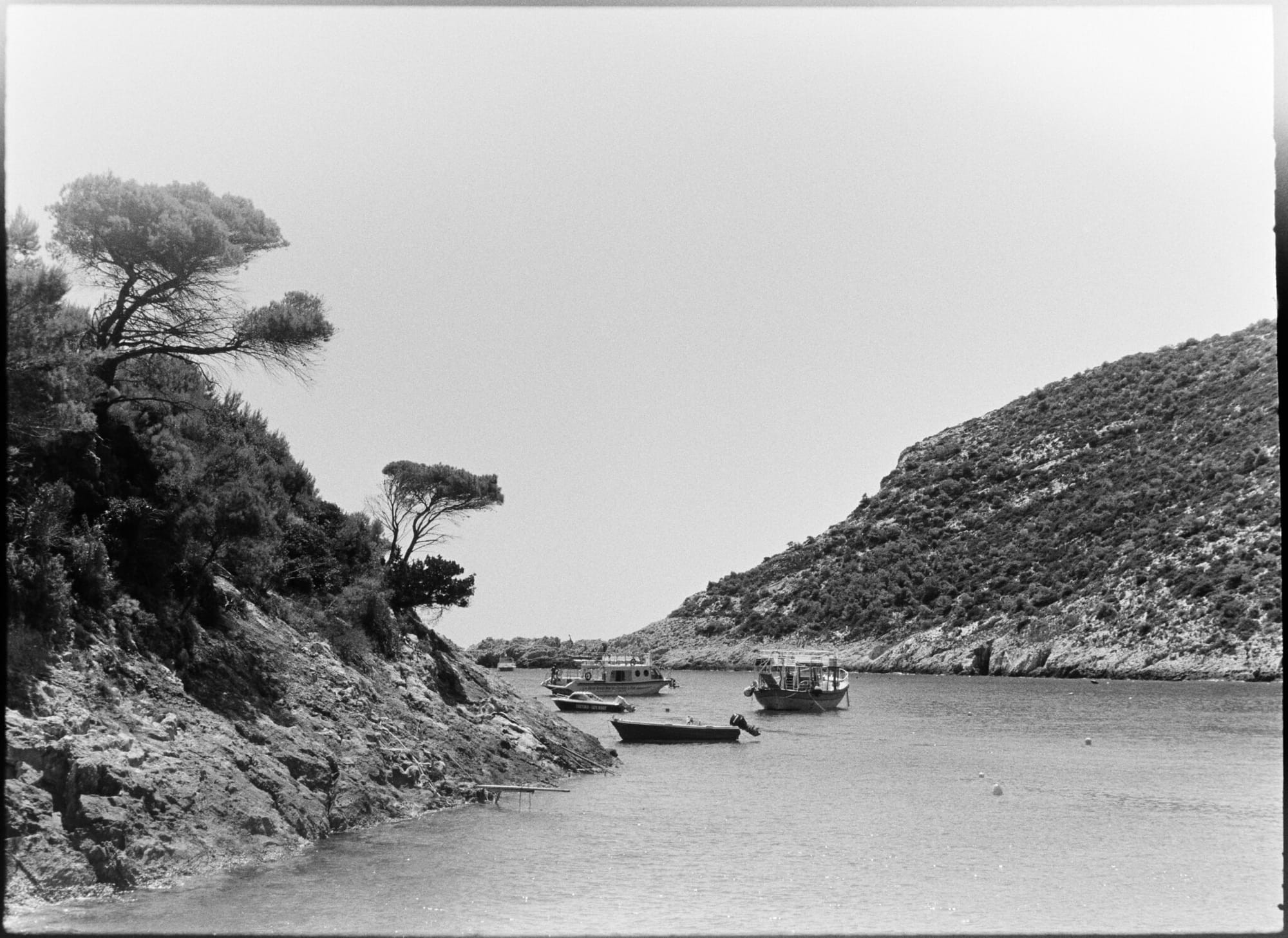 Serene coastal scene with boats anchored in a bay.