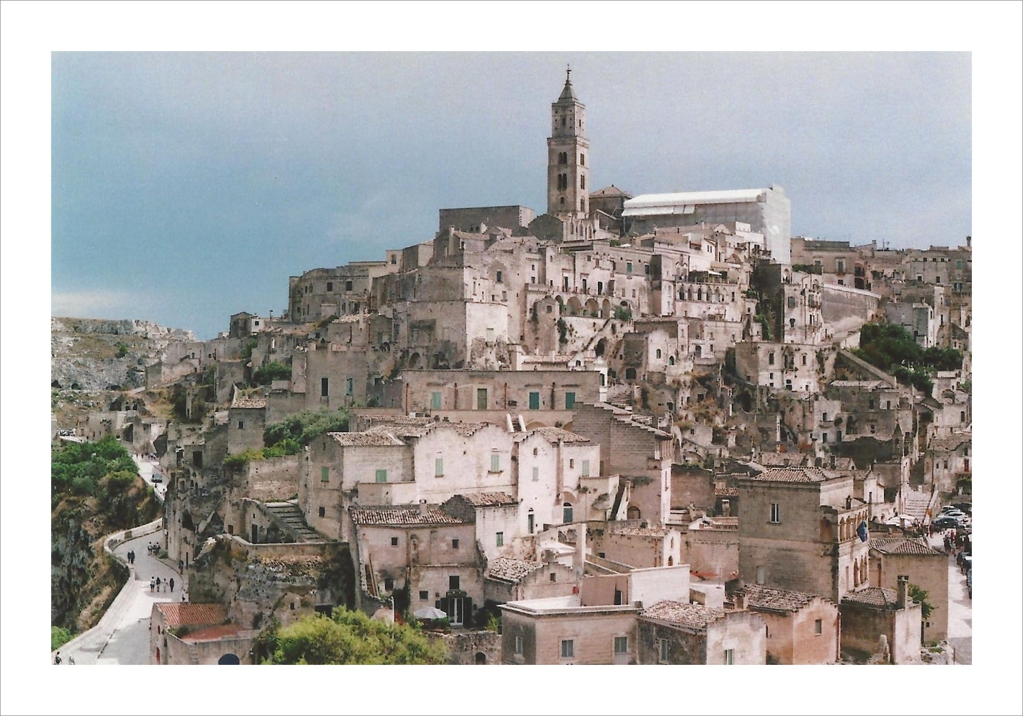 Ancient hillside town of Matera with bell tower on film.