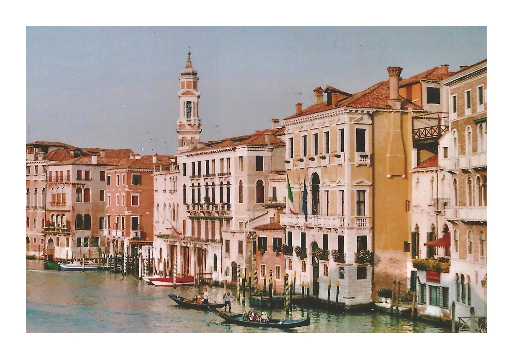 Venice Grand Canal with gondolas and colorful buildings on film.
