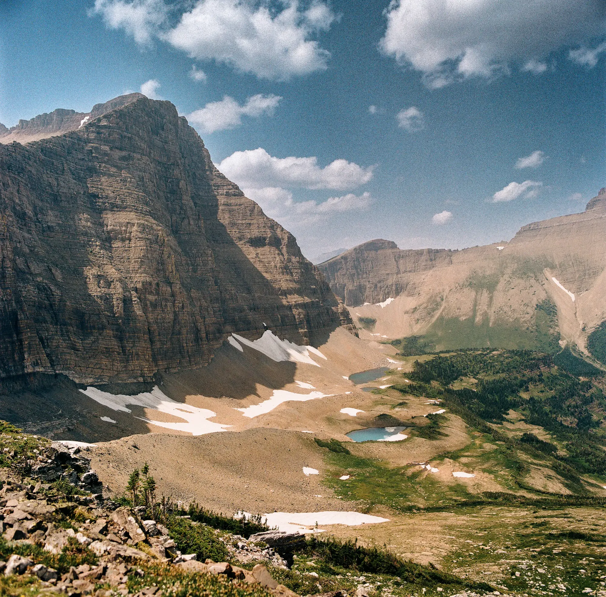 Valley view with lakes and layered peaks on film.