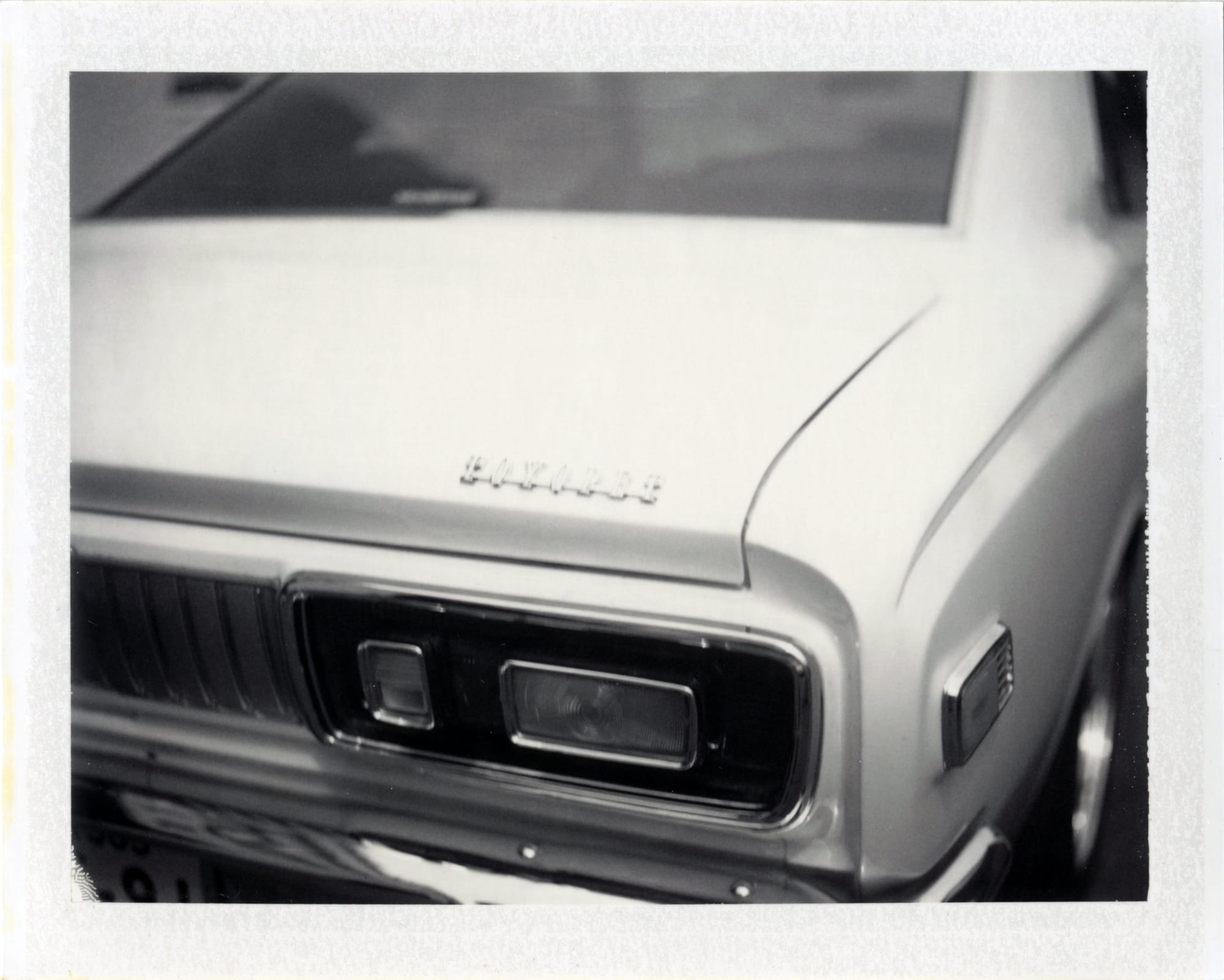 Close-up detail of Camaro badging showing chrome trim and body curves.