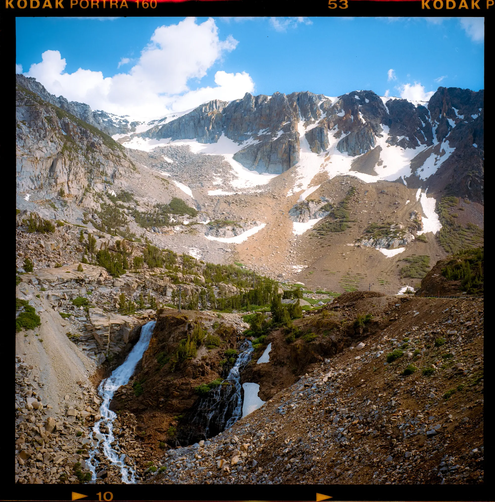 Snow-capped mountain with waterfall and glacier on medium format color film.