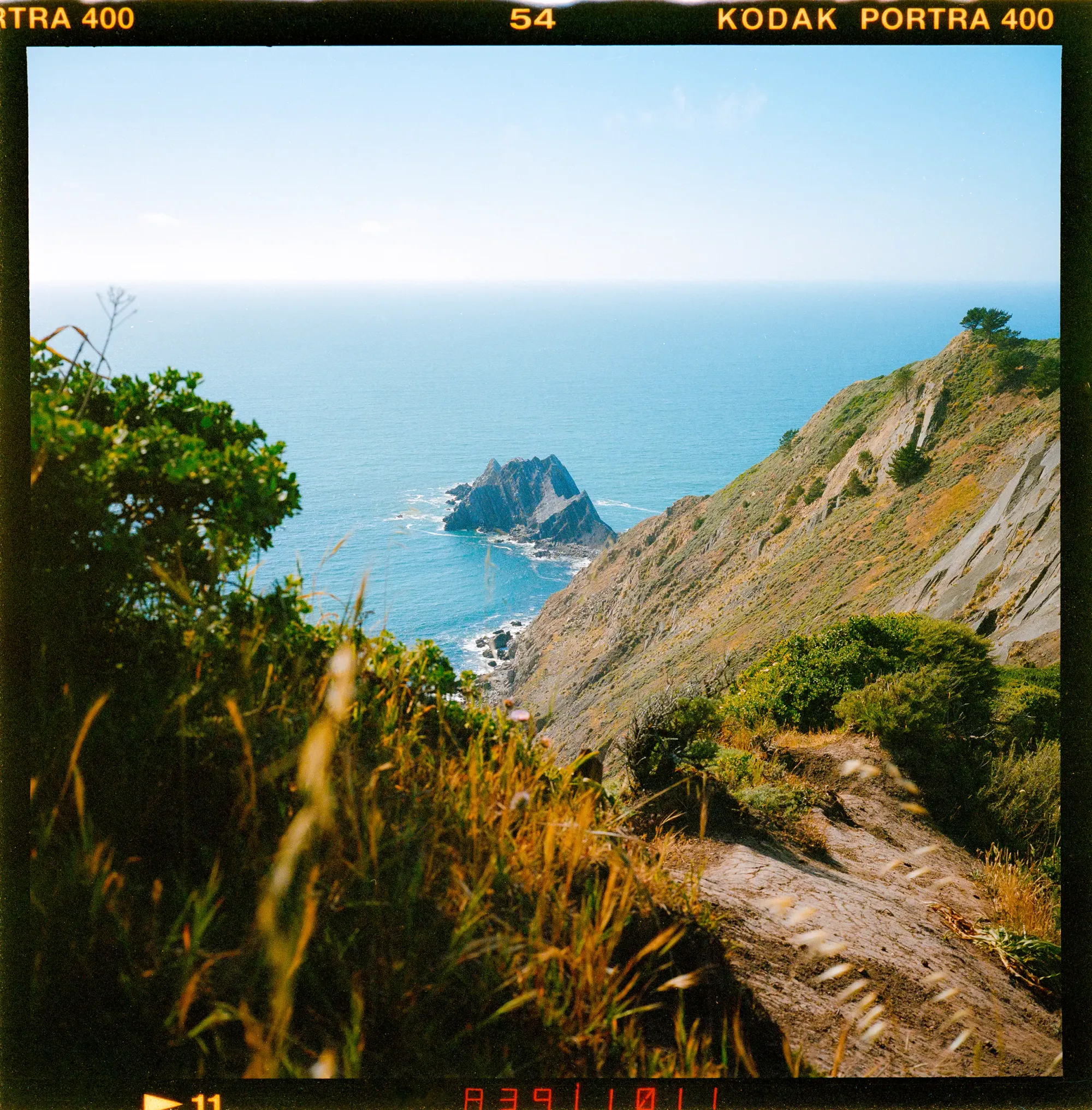 Rocky California coastline with turquoise water shot on Kodak Portra 400.