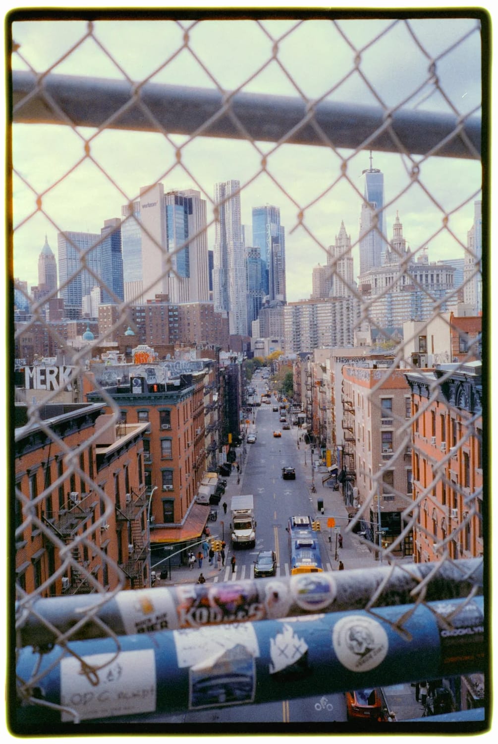 New York City skyline through a chain-linked fence.