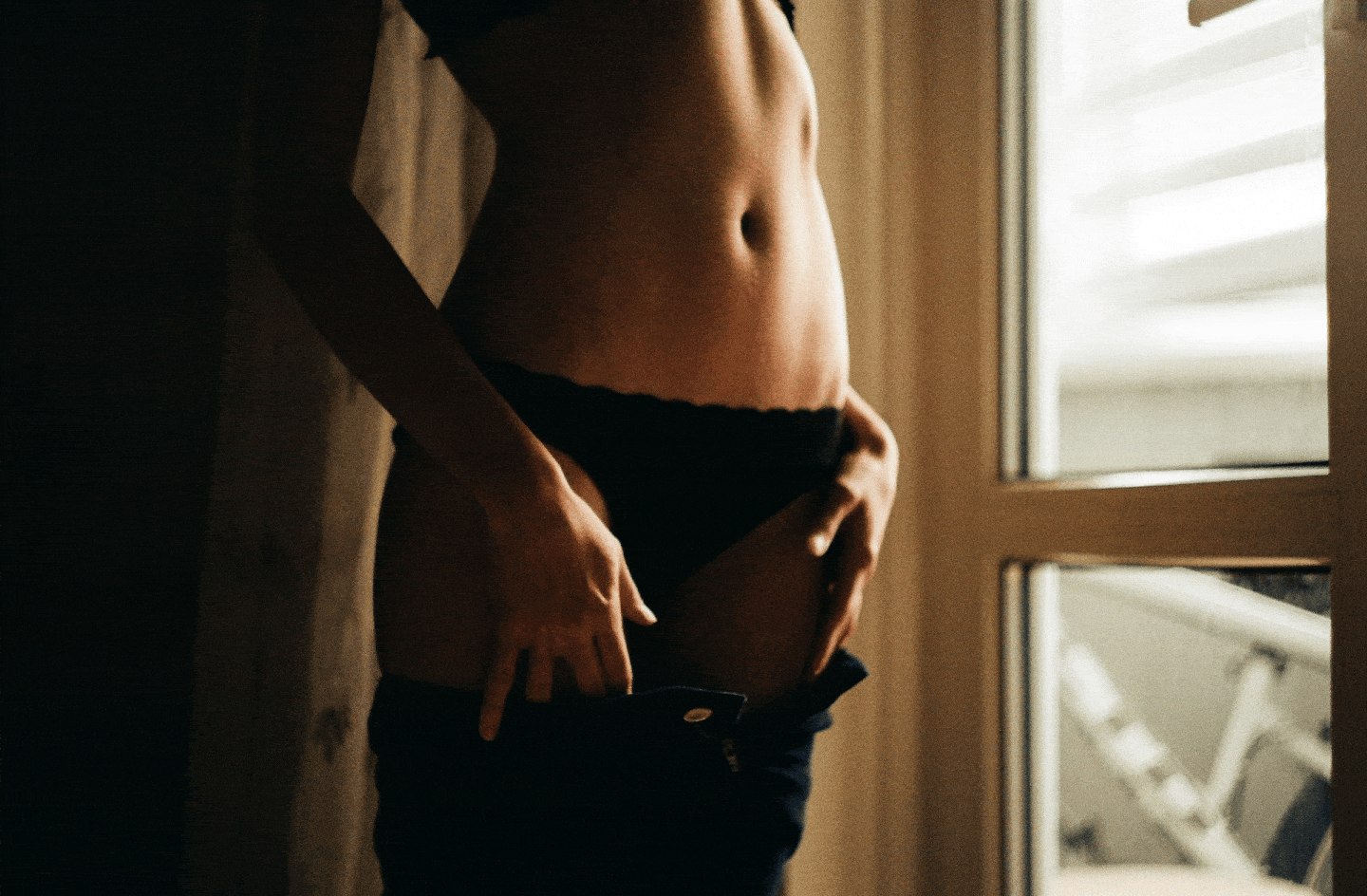 Lingerie-clad young woman in a Minsk apartment.