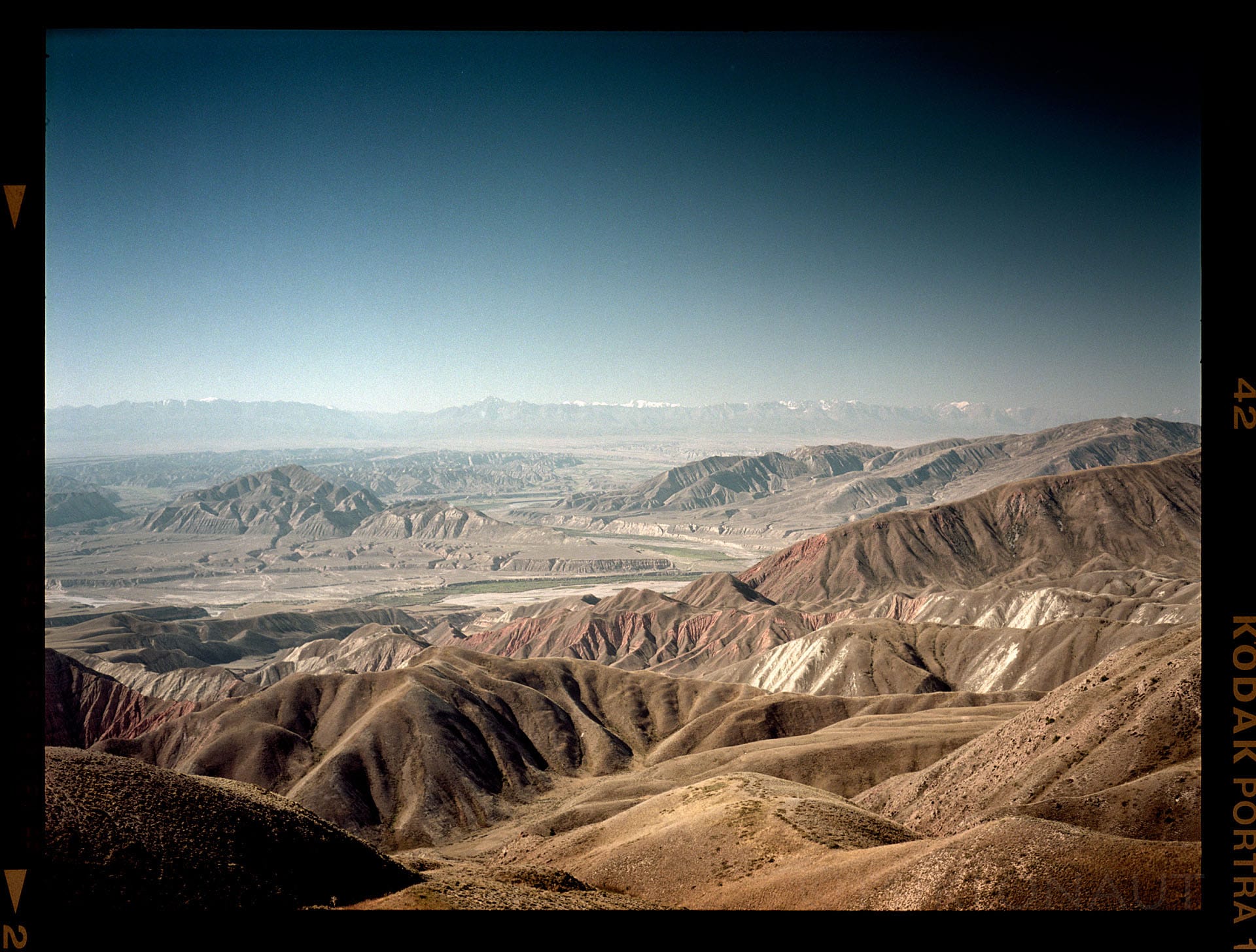 Eroded mountain ridges display striations in warm desert tones.
